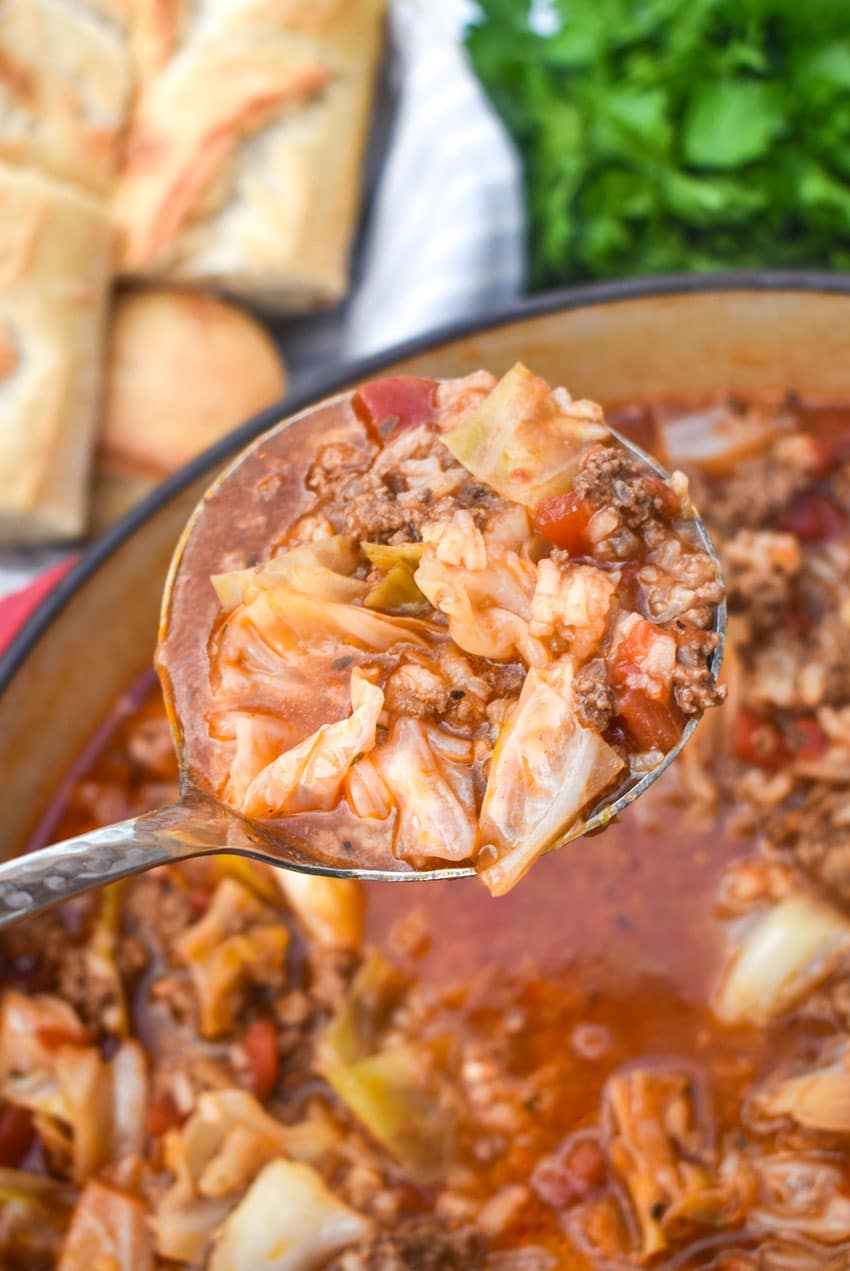a silver ladle lifting up a scoop of unstuffed cabbage soup