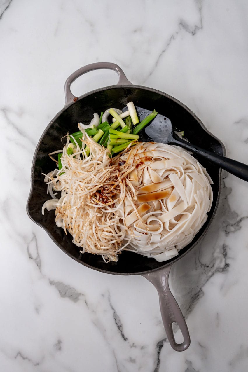 beef chow fun ingredients in a large cast iron skillet