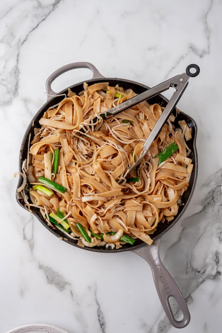 beef chow fun ingredients in a large cast iron skillet