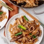 beef chow fun on two small white plates