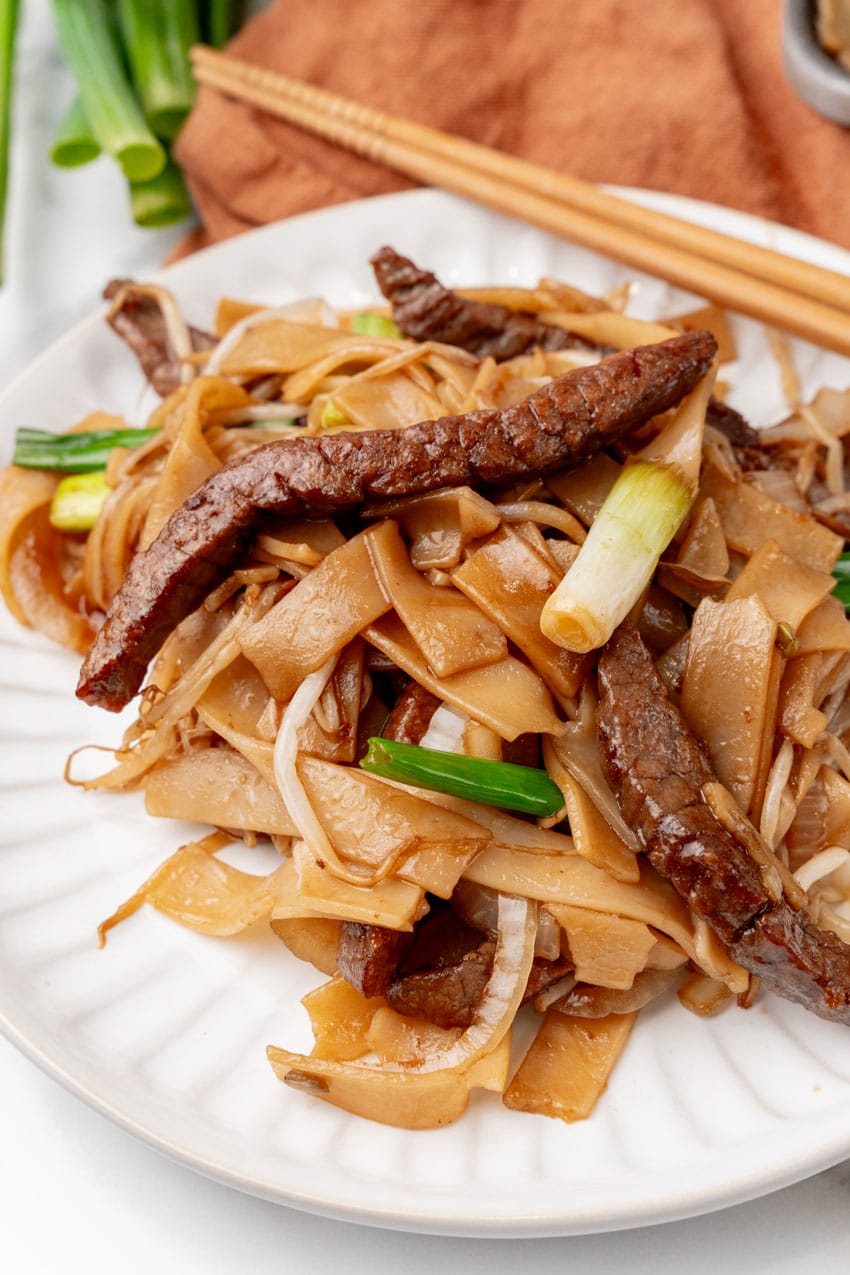beef chow fun on two small white plates