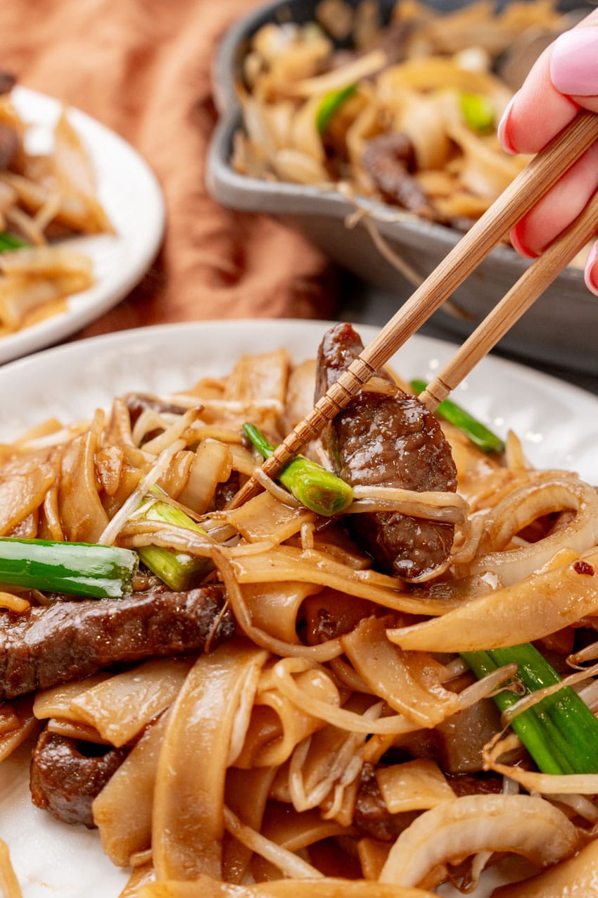 beef chow fun on two small white plates