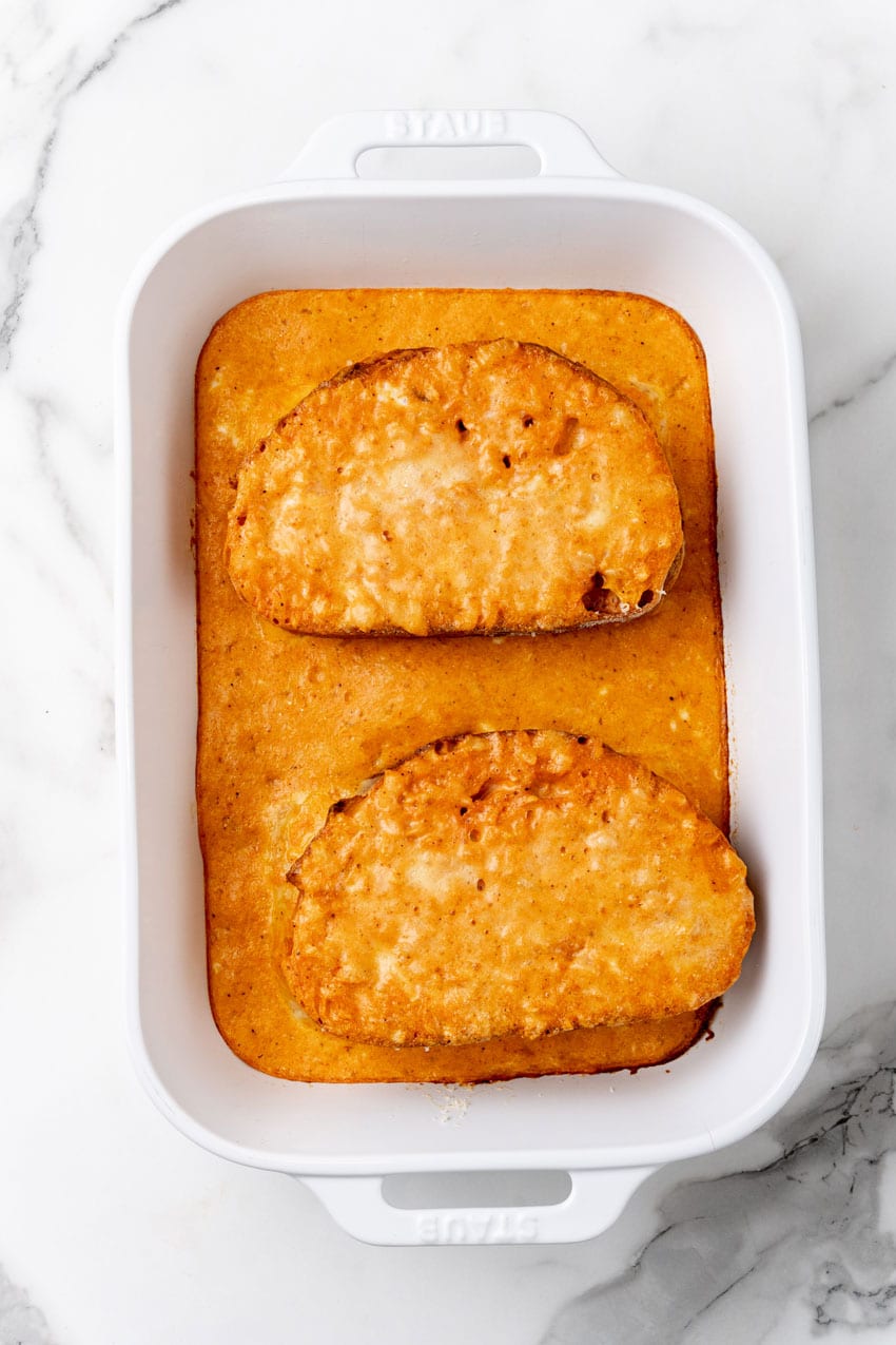 tomato soup grilled cheese casserole in a white baking dish