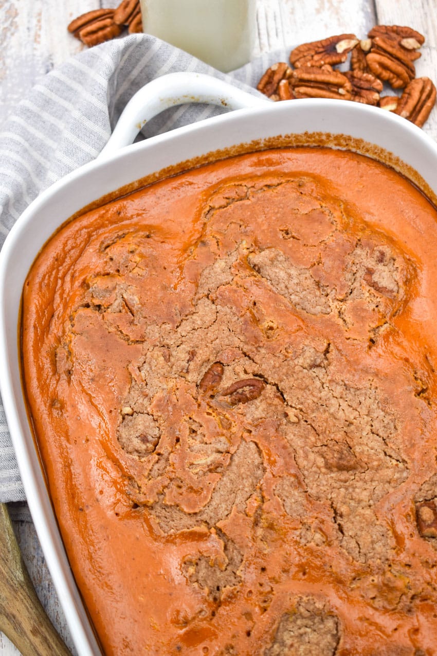 pumpkin pecan dump cake in a white baking dish