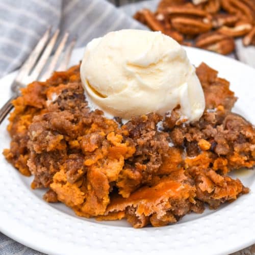 pumpkin pecan dump cake on a small white plate