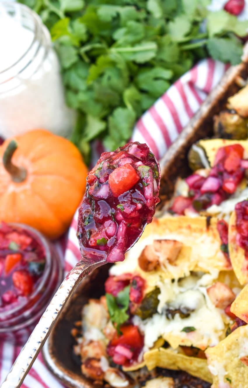 a silver spoon holding up a scoop of homemade cranberry relish