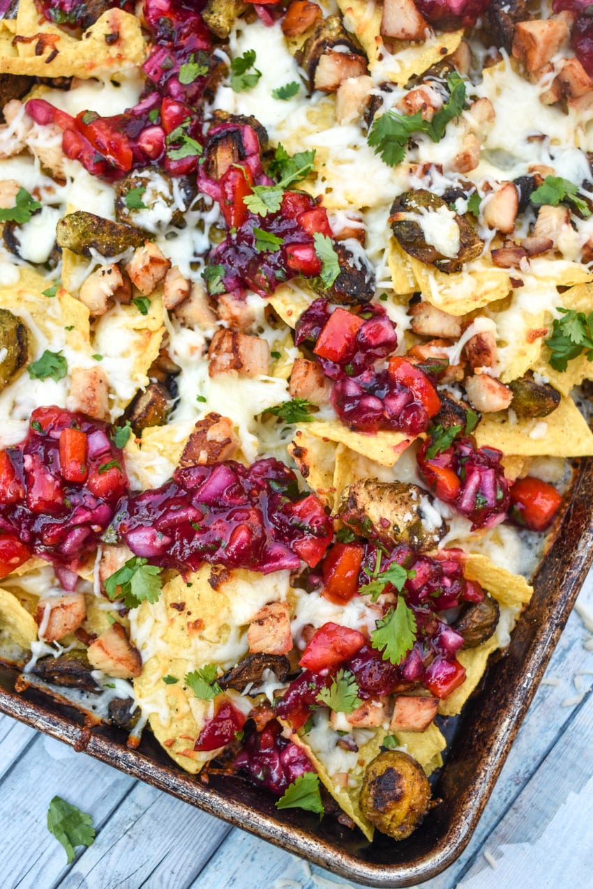 a close up of thanksgiving nachos on a rimmed baking sheet