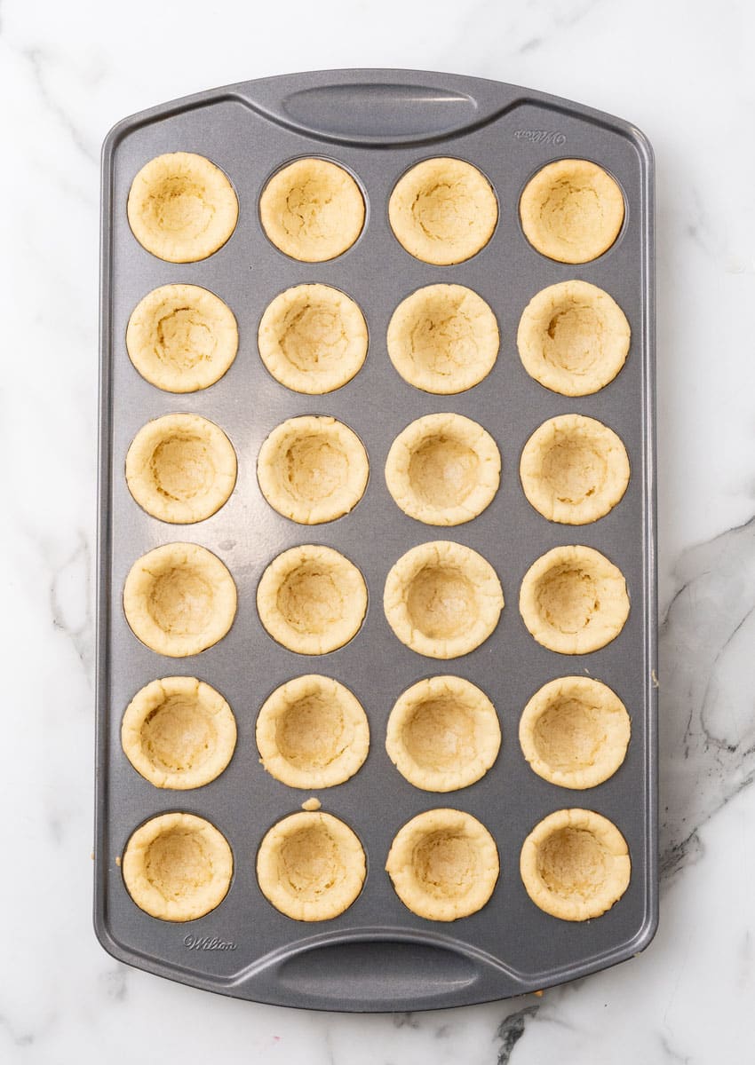 baked sugar cookie cups in a mini muffin tin pan