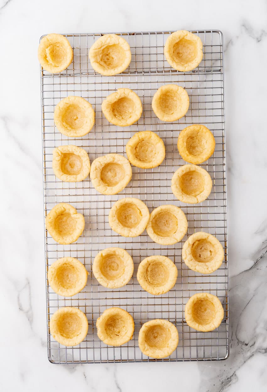 homemade sugar cookie cups cooling on a wire rack