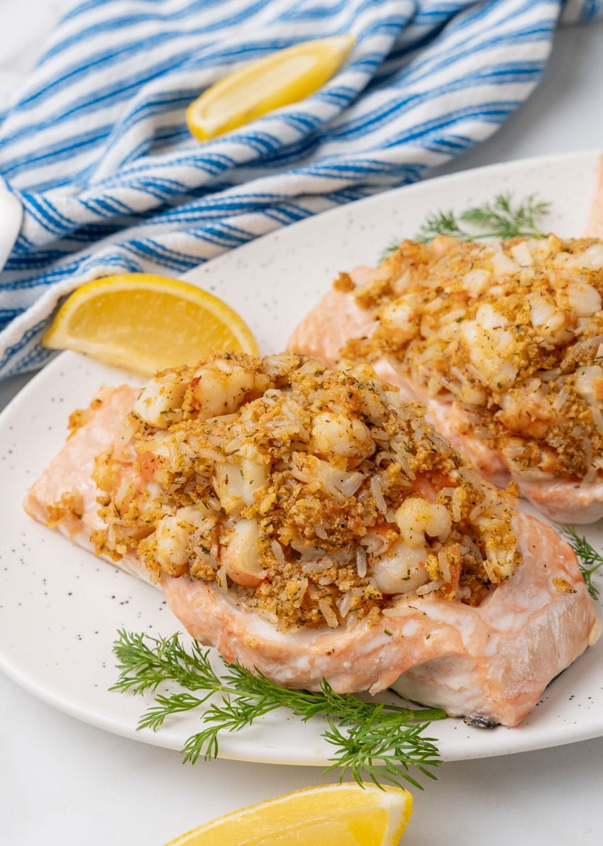 three crab stuffed salmon filets on a white serving platter