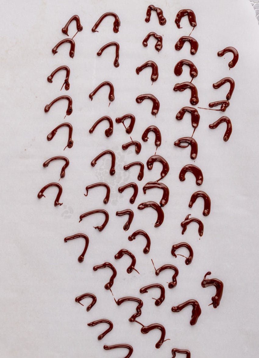 mini chocolate handles hardening on white parchment paper