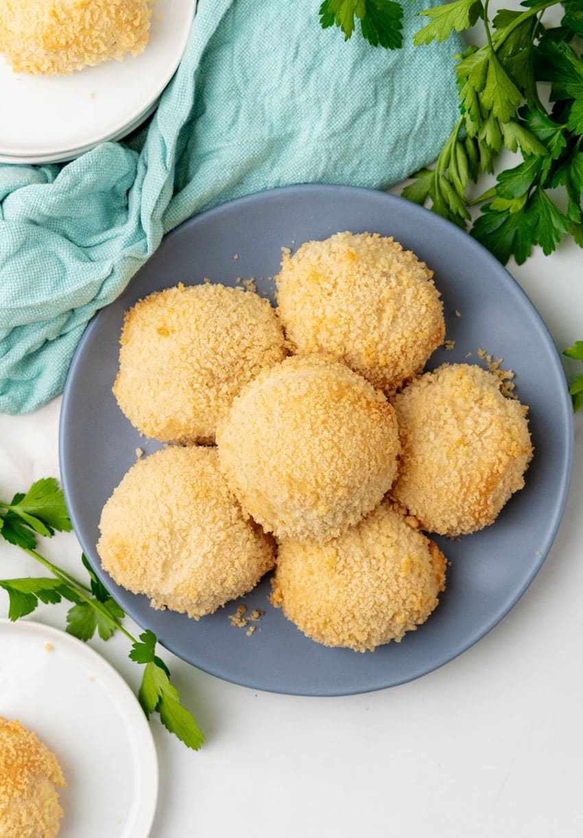 crispy chicken pillows piled on a gray plate