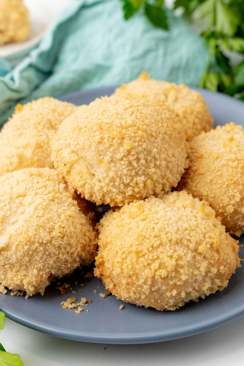 crispy chicken pillows piled on a gray plate