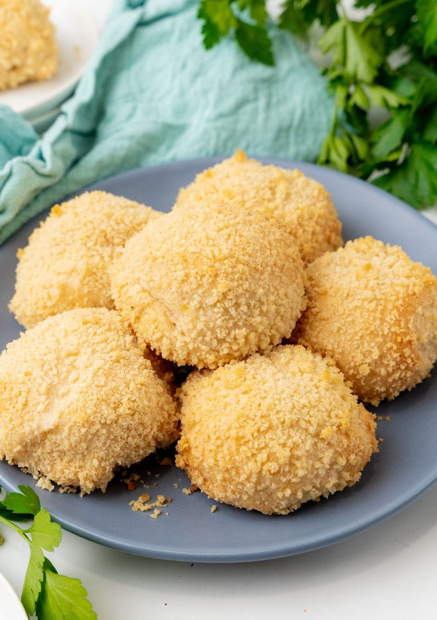 crispy chicken pillows piled on a gray plate
