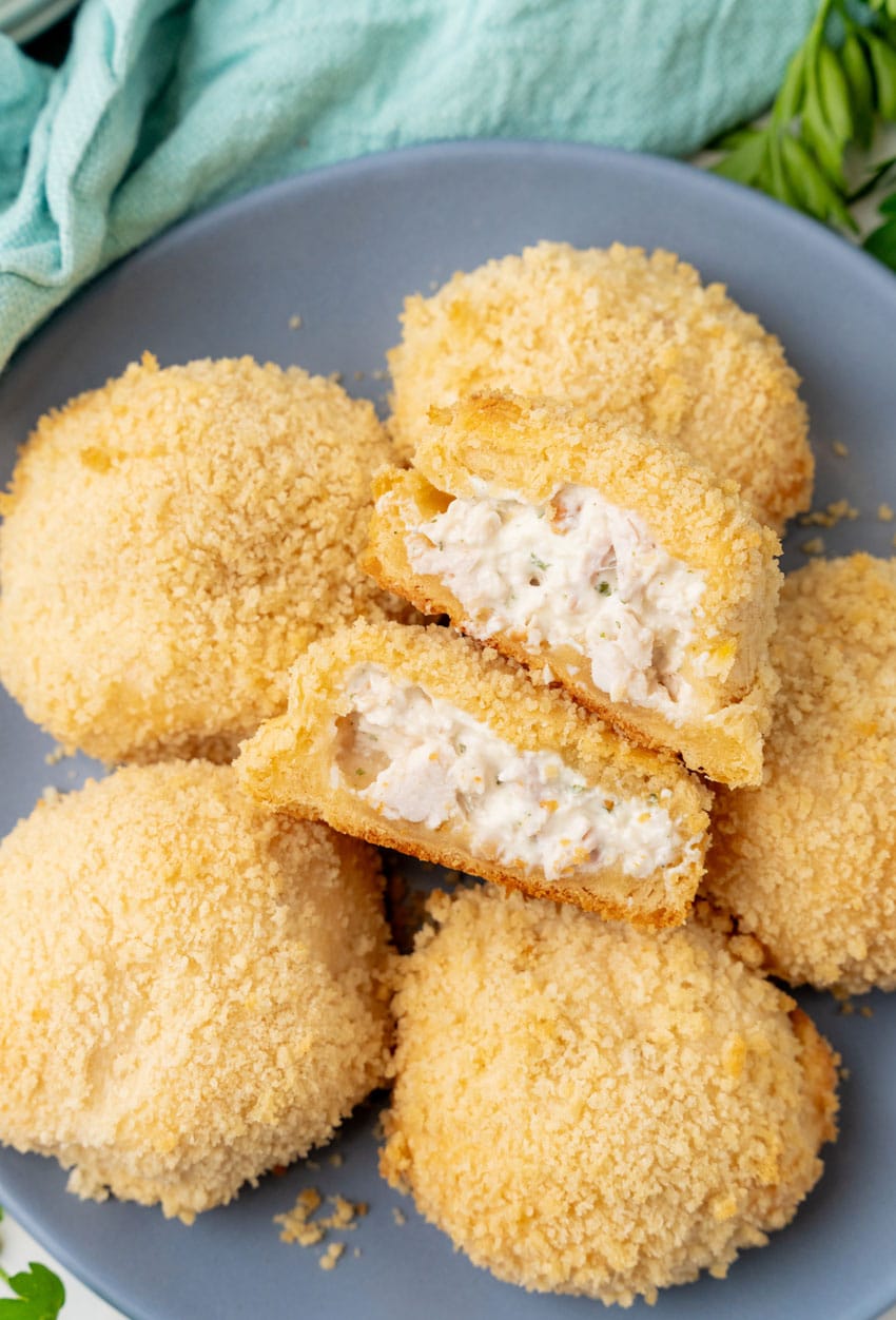 crispy chicken pillows piled on a gray plate