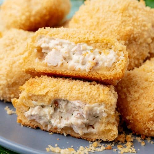 crispy chicken pillows piled on a gray plate