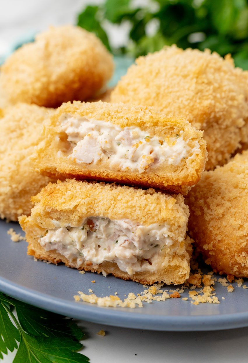 crispy chicken pillows piled on a gray plate