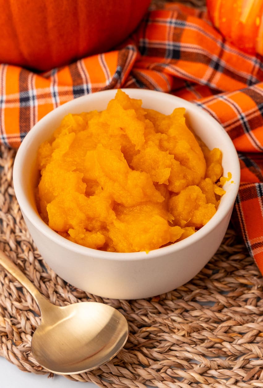homemade pumpkin puree in a small white bowl