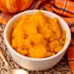 homemade pumpkin puree in a small white bowl