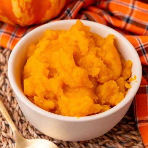 homemade pumpkin puree in a small white bowl