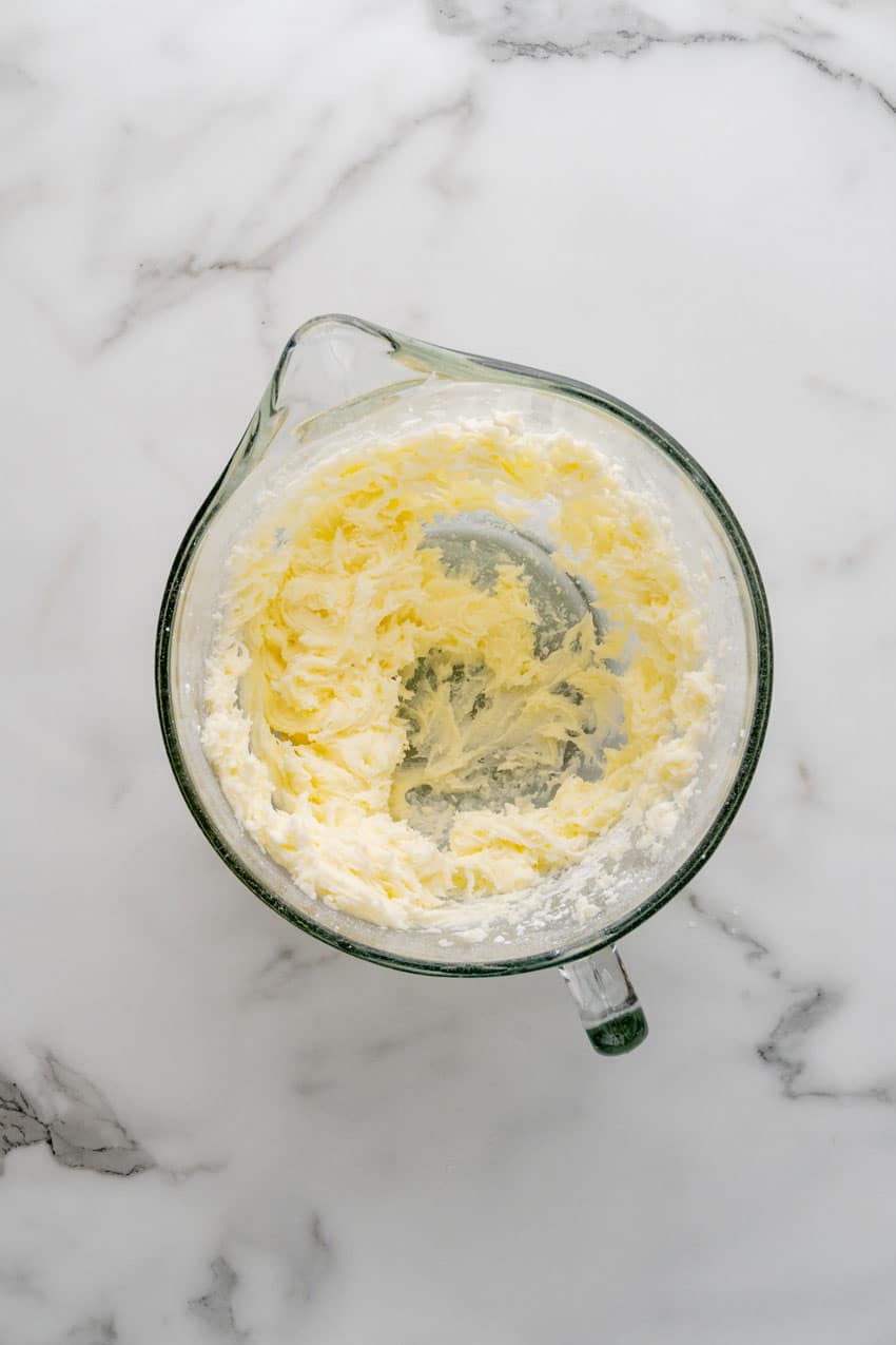 homemade vanilla buttercream frosting in a glass mixing bowl