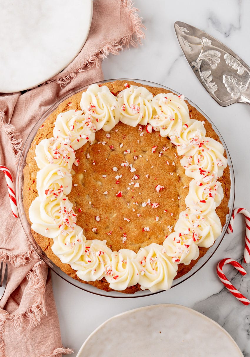 a peppermint sugar cookie cake on a marble countertop with candy canes in the background