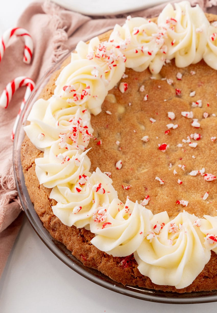 a peppermint sugar cookie cake on a marble countertop with candy canes in the background
