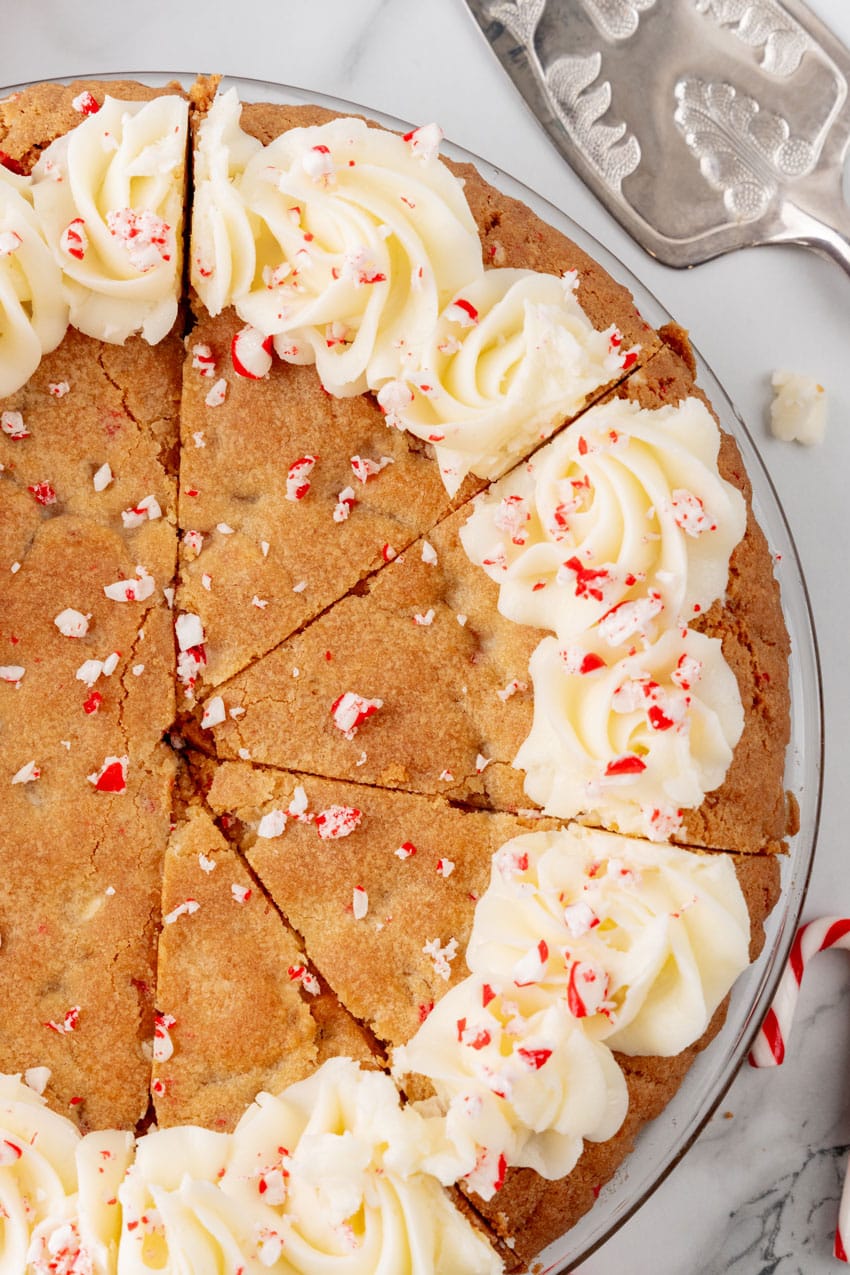 a peppermint sugar cookie cake on a marble countertop with candy canes in the background
