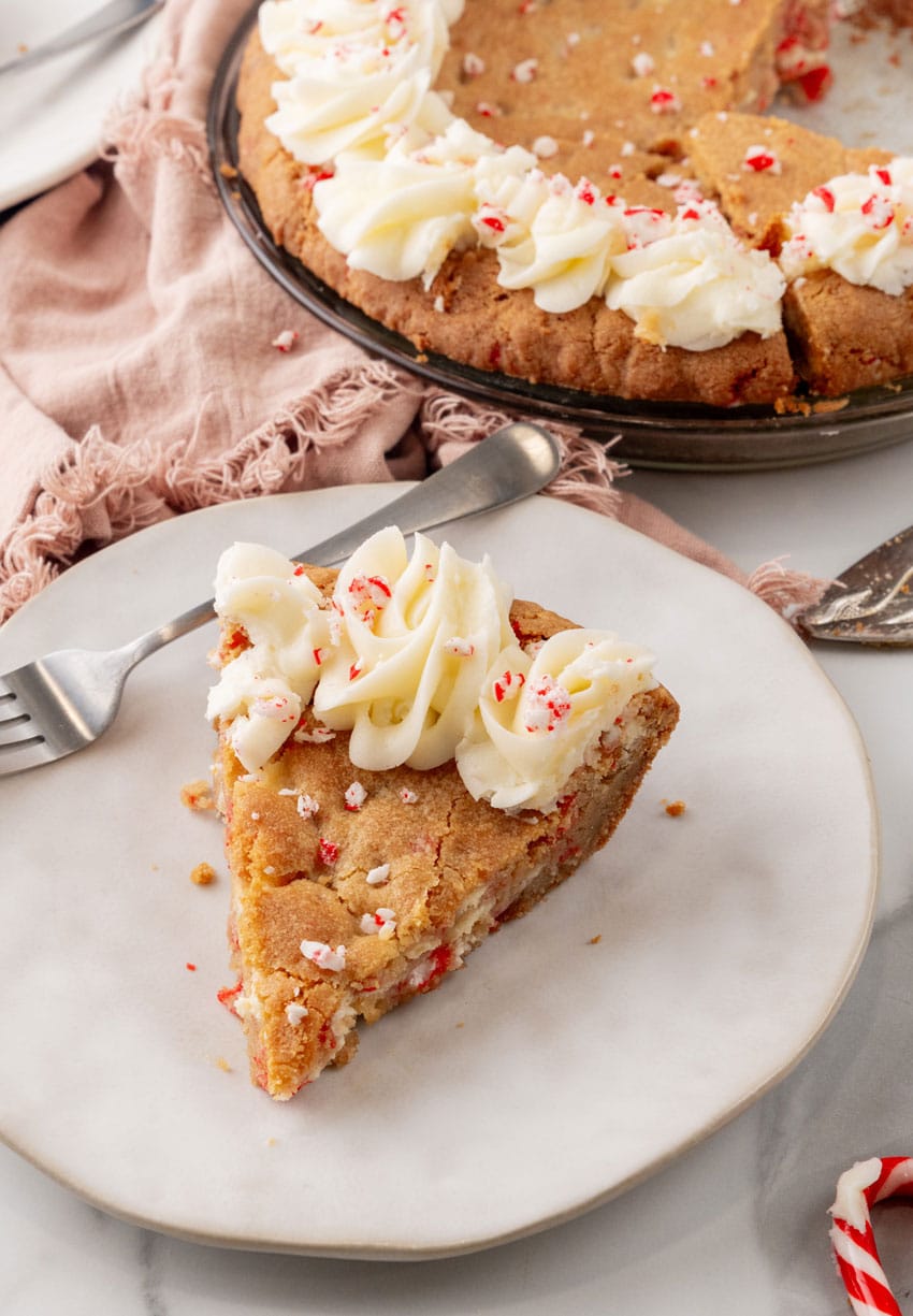 a slice of peppermint sugar cookie cake on a white plate