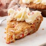 a slice of peppermint sugar cookie cake on a white plate