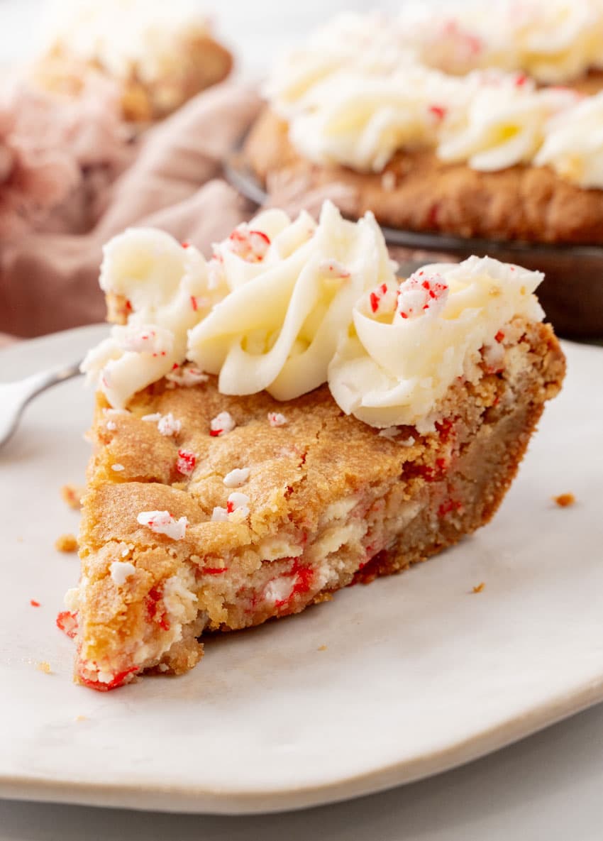 a slice of peppermint sugar cookie cake on a white plate