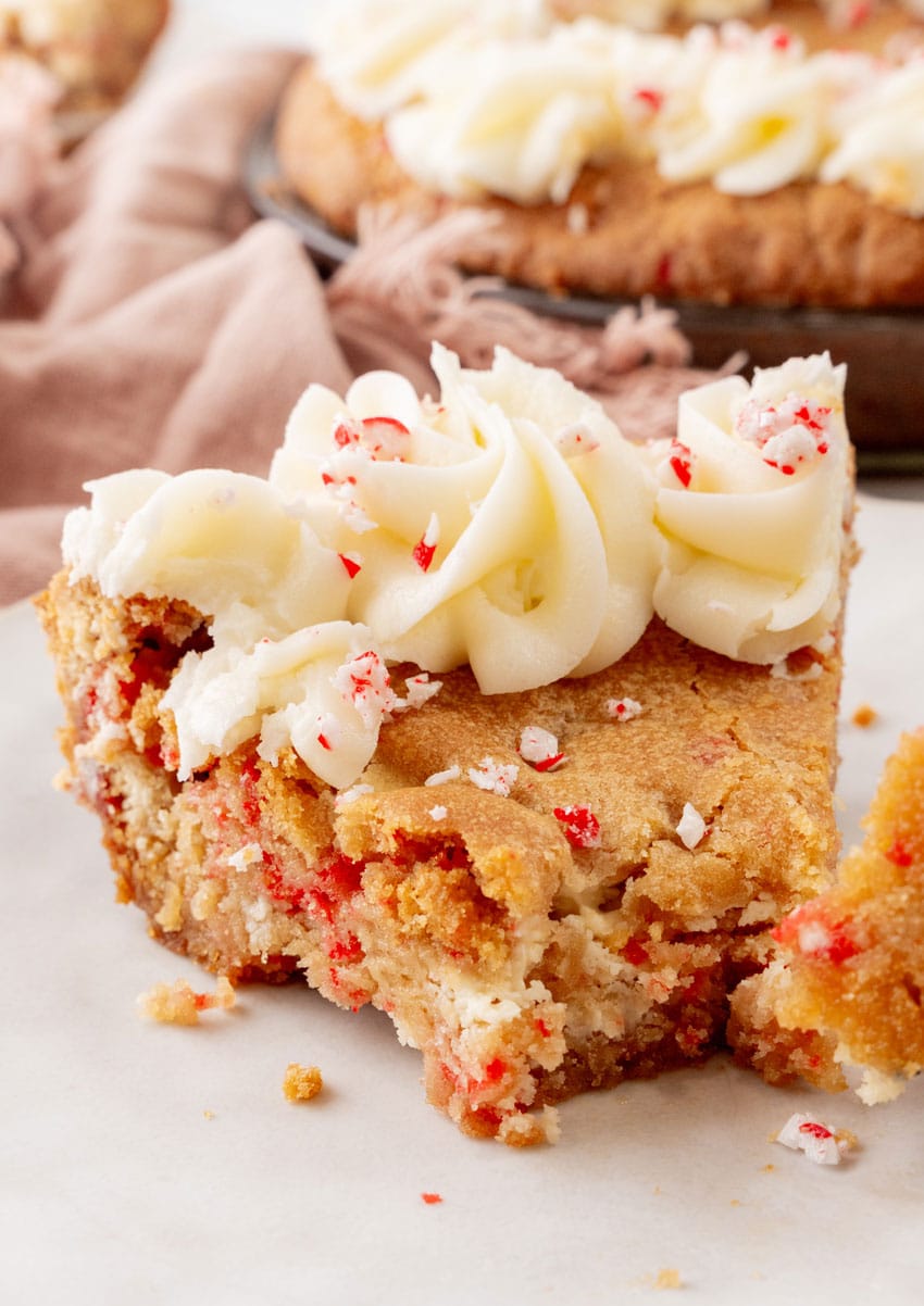 a slice of peppermint sugar cookie cake on a white plate