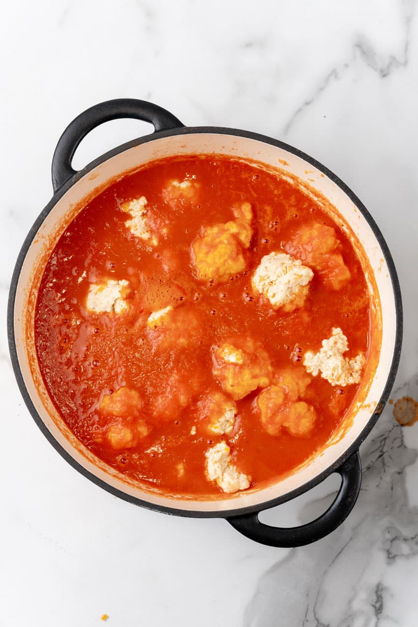 homemade tomato bisque with cheddar bay dumplings in a large dutch oven