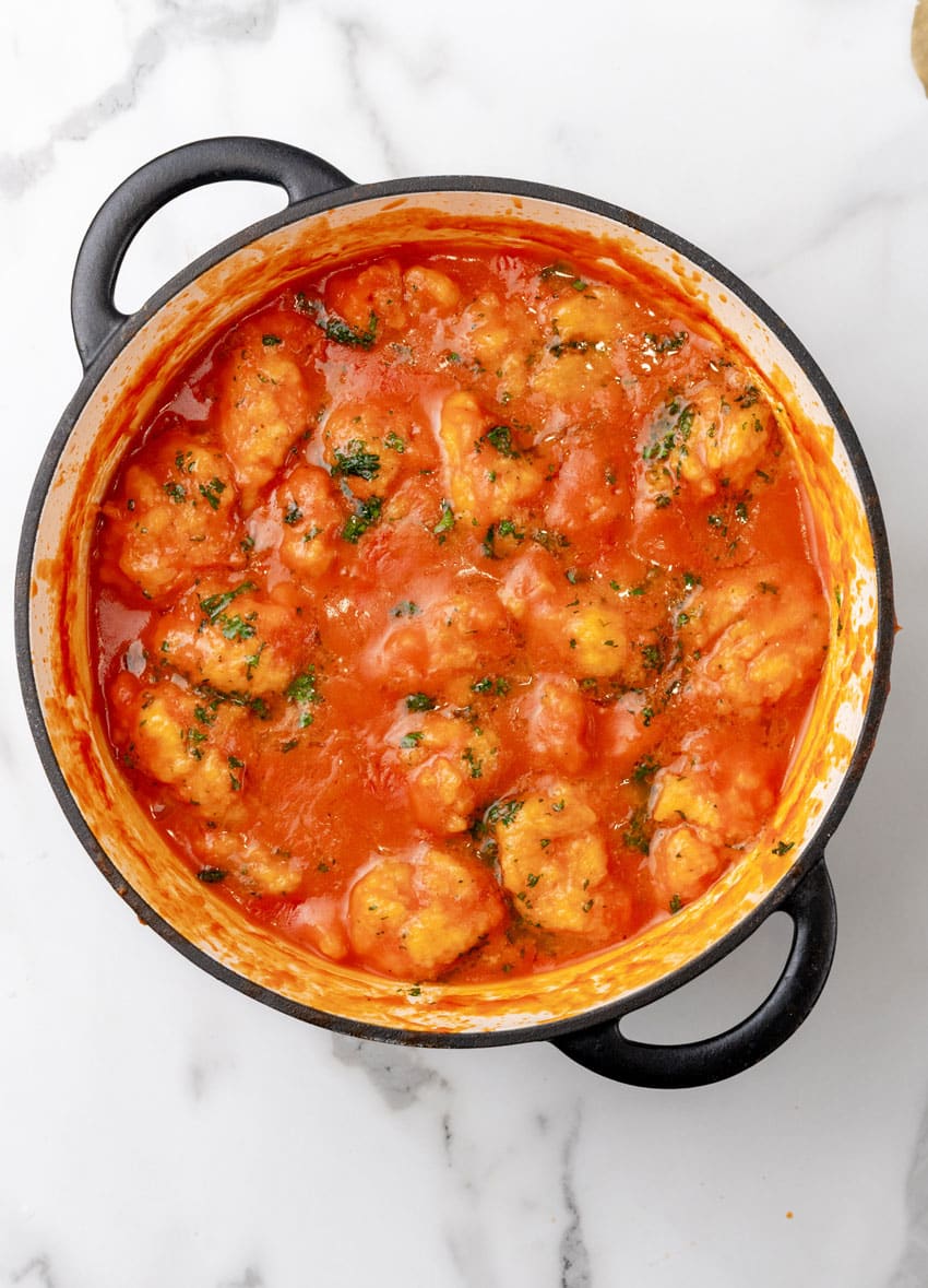 homemade tomato bisque with cheddar bay dumplings in a large dutch oven