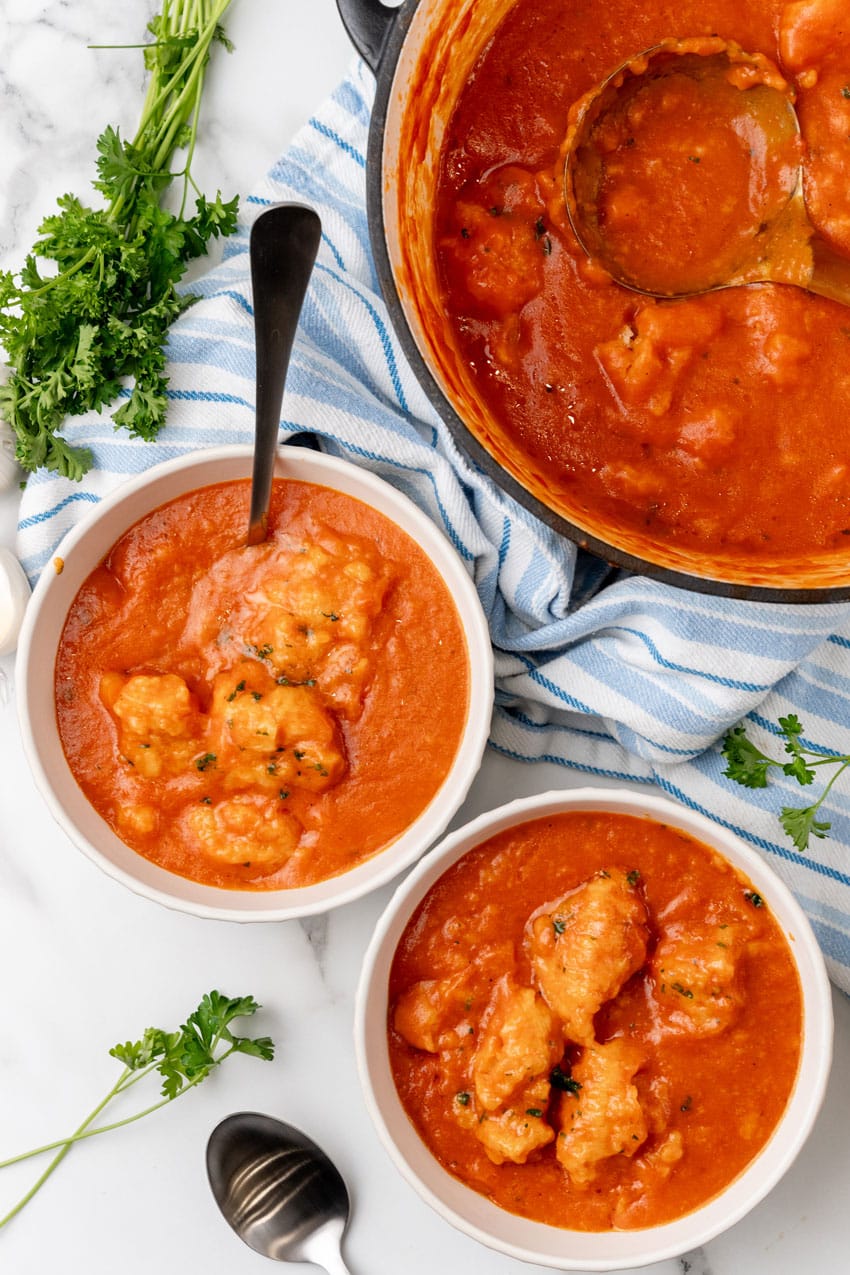 tomato bisque with cheddar bay dumplings in two white bowls