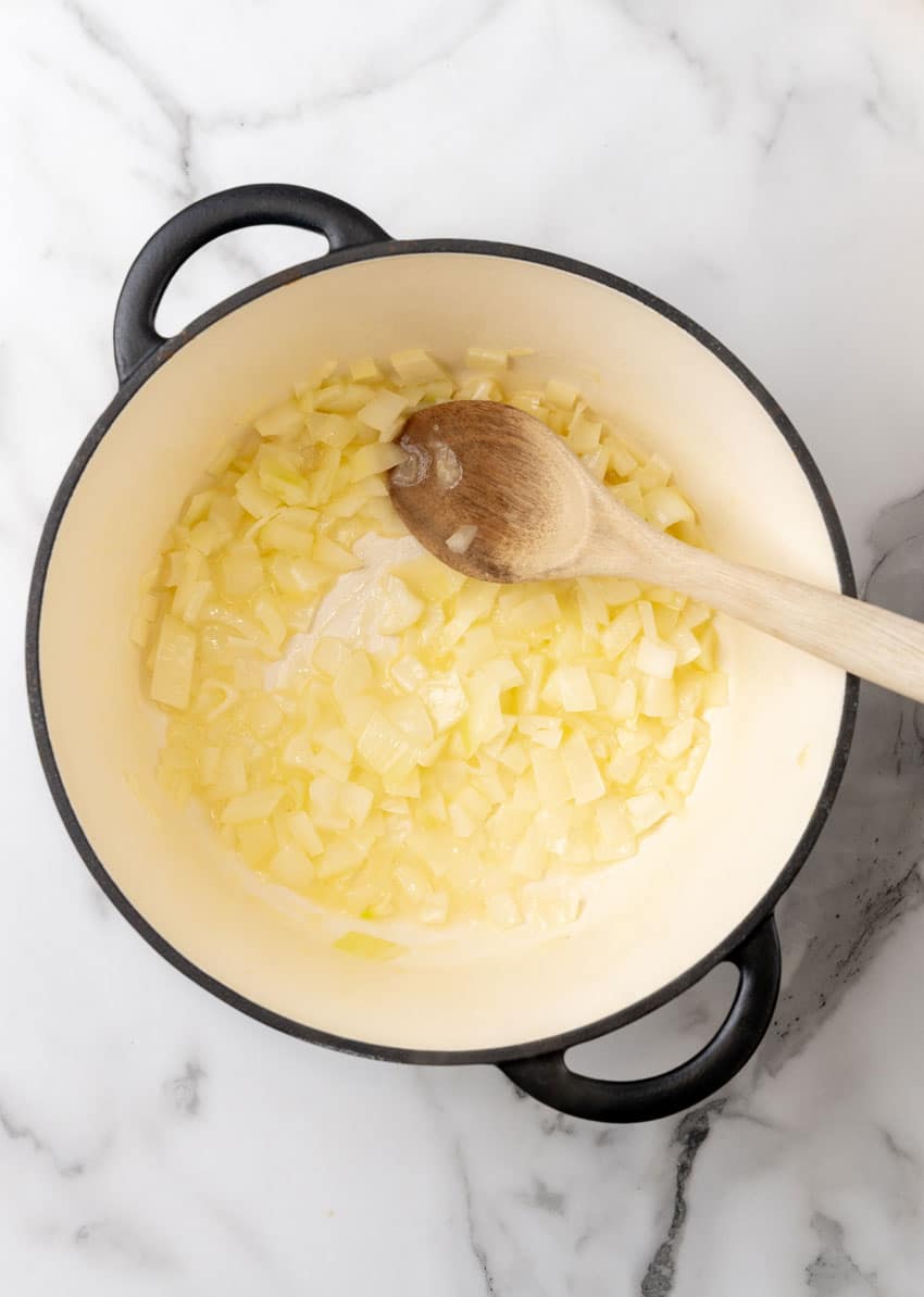 diced onions in a roux in a large dutch oven