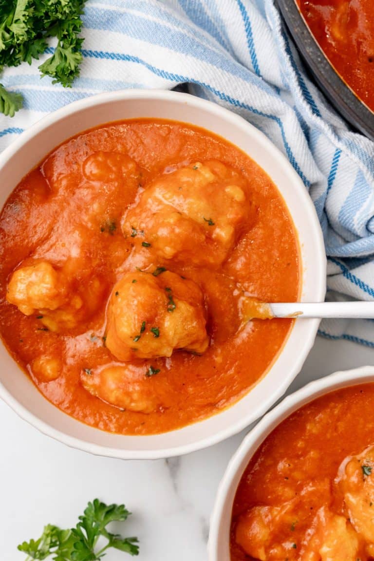 tomato bisque with cheddar bay dumplings in two white bowls