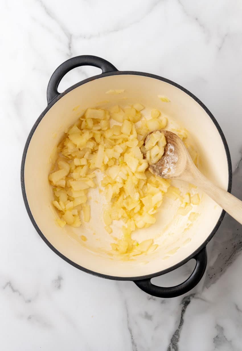 diced onions in a roux in a large dutch oven