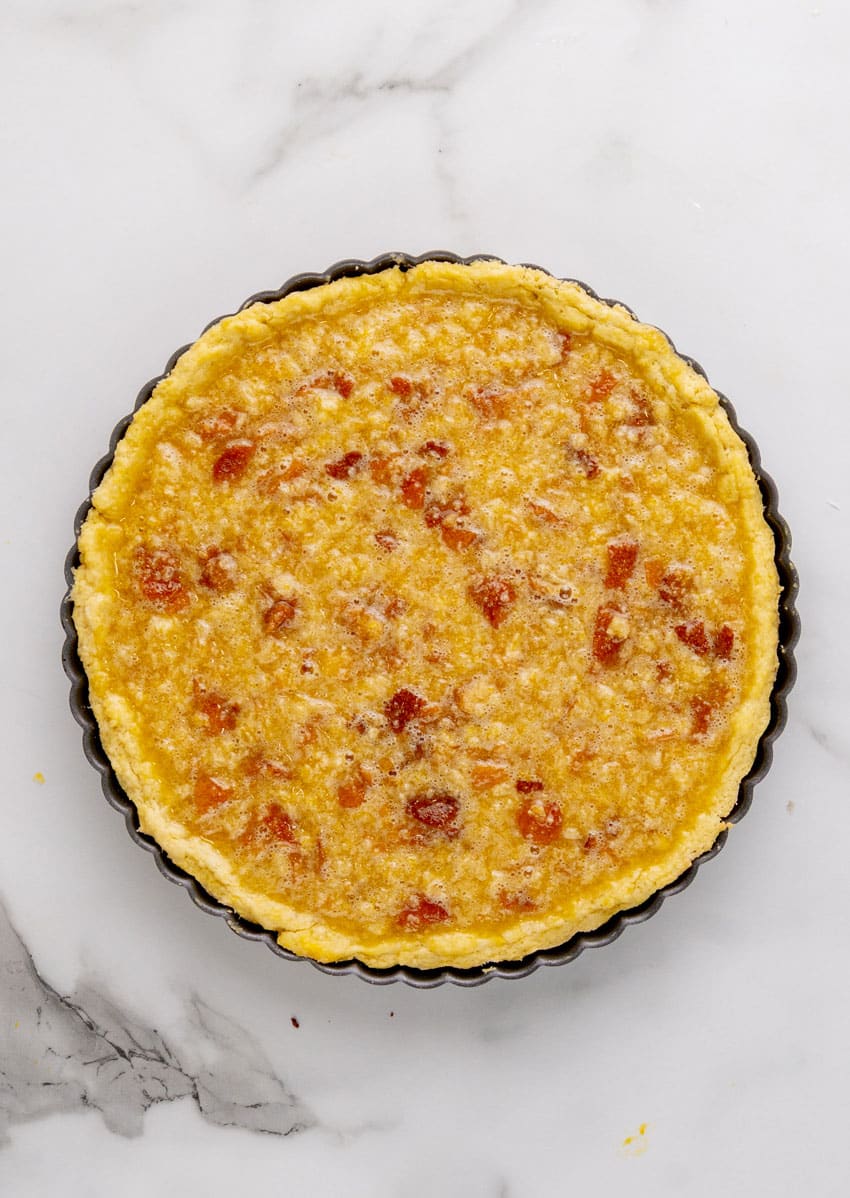 an unbaked homemade treacle tart on a marble countertop