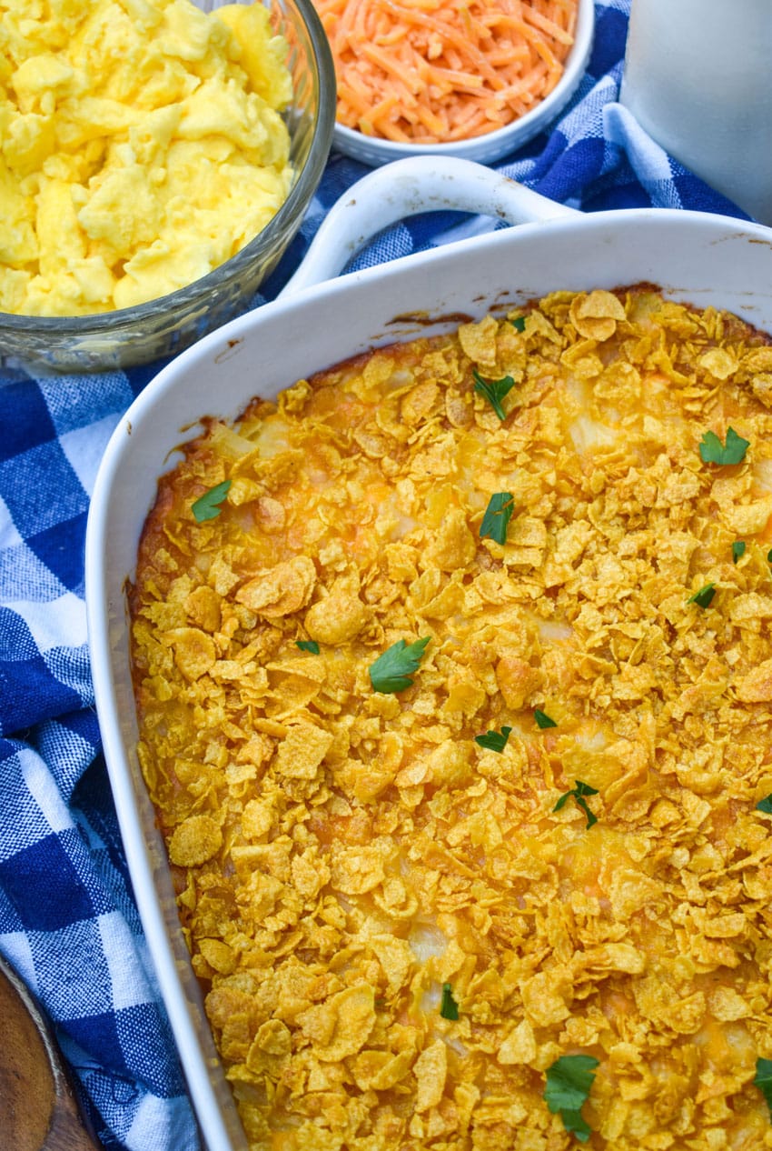 cheesy hashbrown casserole in a white baking dish