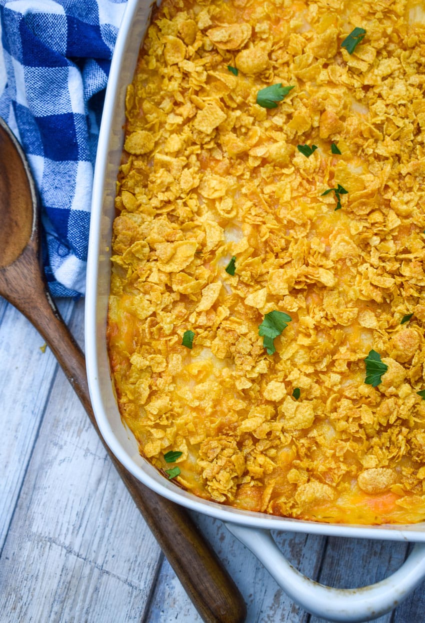 cheesy hashbrown casserole in a white baking dish