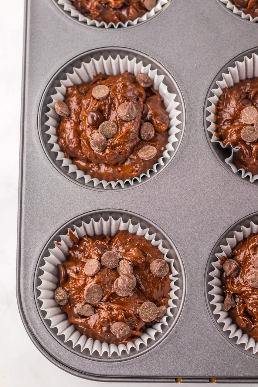 double chocolate chunk muffin batter in a paper lined muffin tin