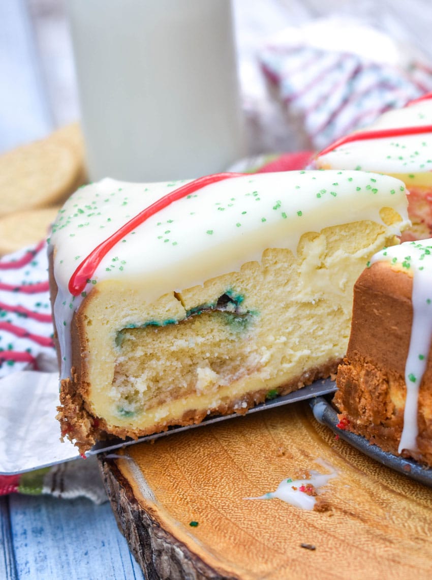 a silver spatula lifting up a slice of little debbie christmas tree cheesecake