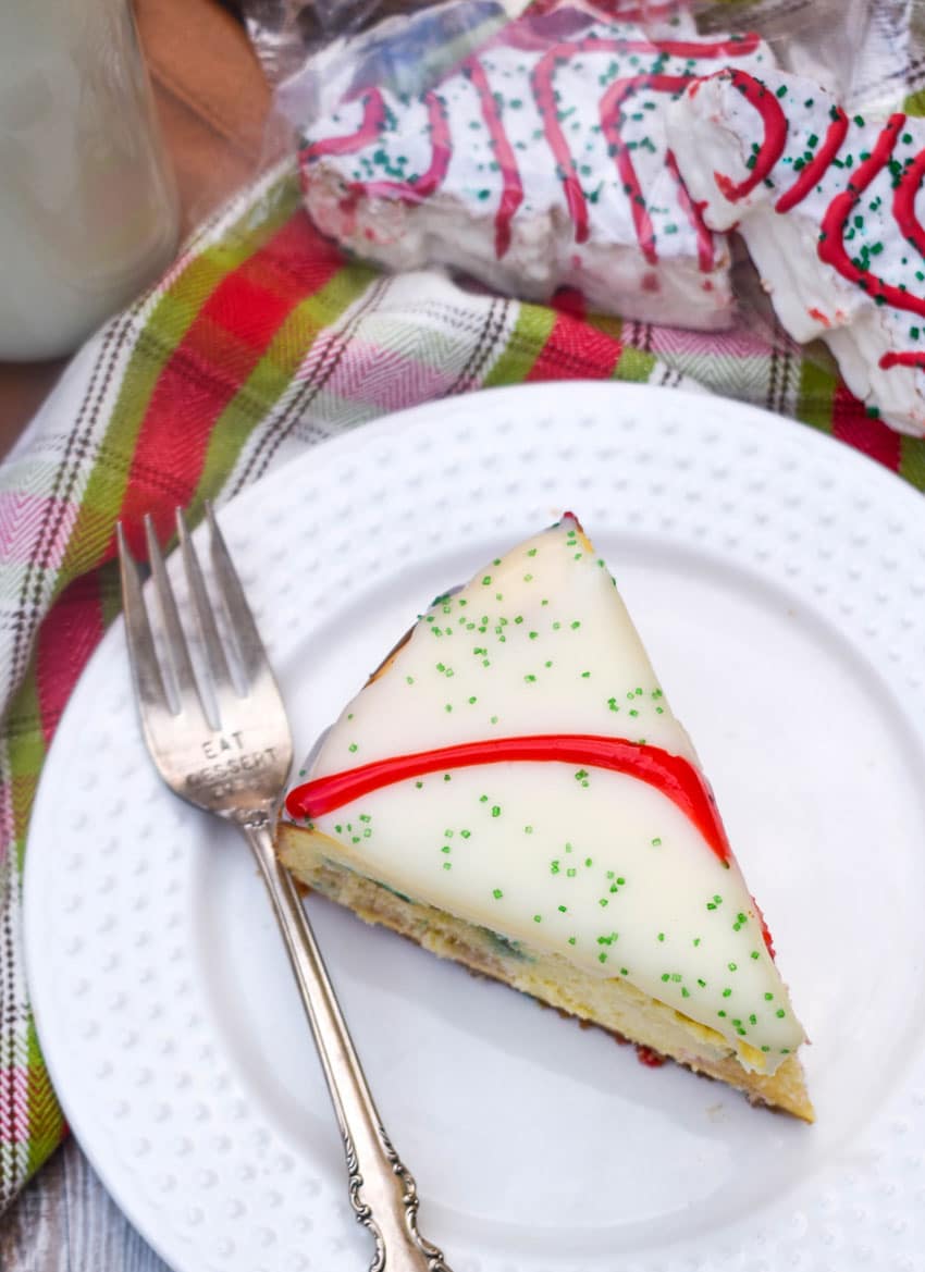 a slice of little debbie christmas tree cheesecake on a small white plate