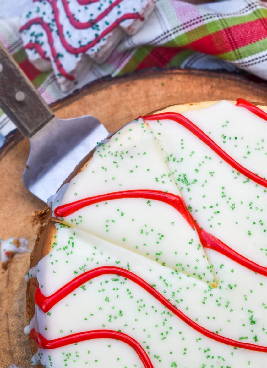 a silver spatula lifting up a slice of little debbie christmas tree cheesecake
