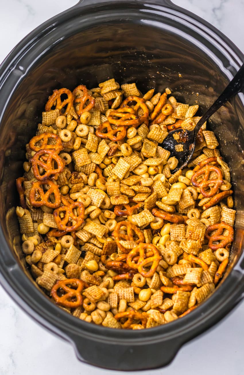 homemade christmas chex mix in a black crockpot