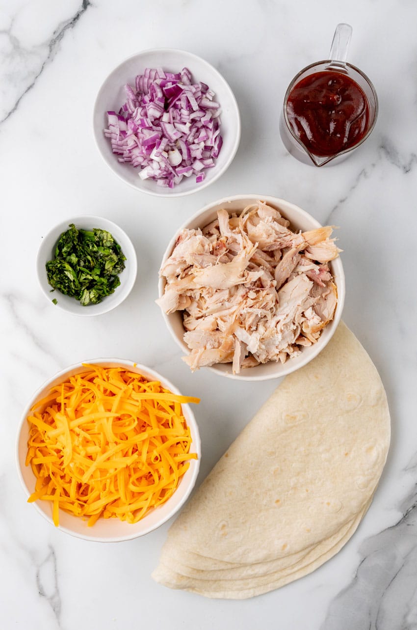an overhead image showing the measured ingredients needed to make a batch of barbecue chicken quesadillas