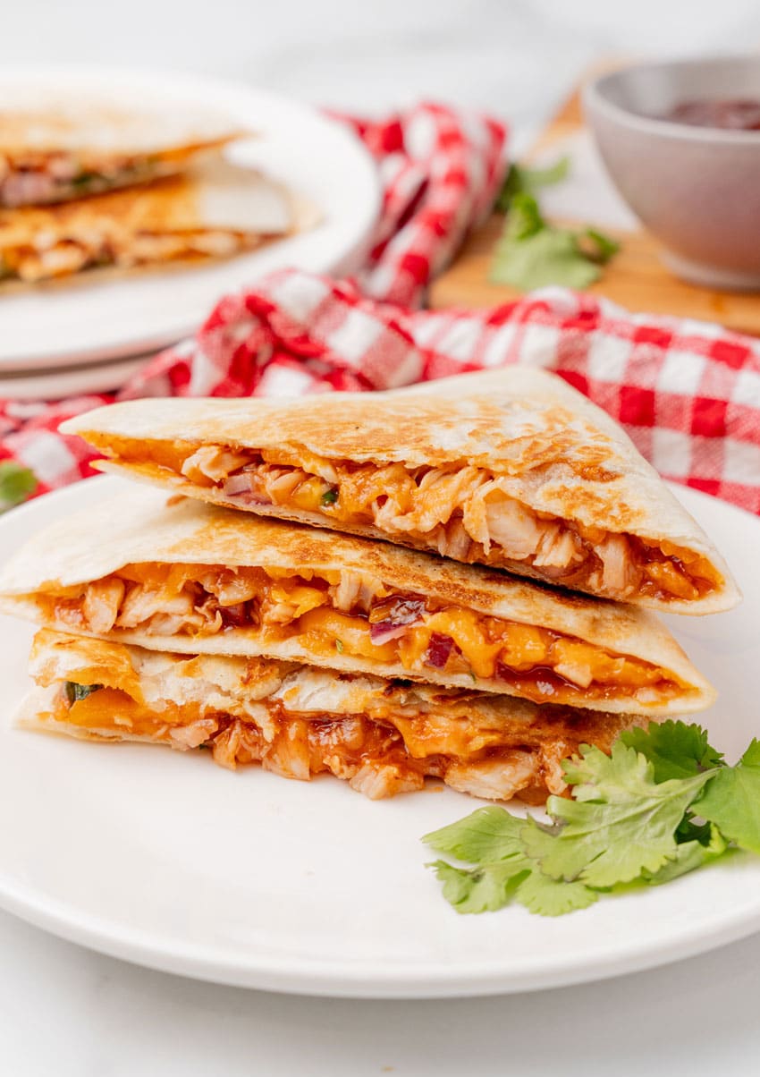 barbecue chicken quesadillas stacked on a white plate