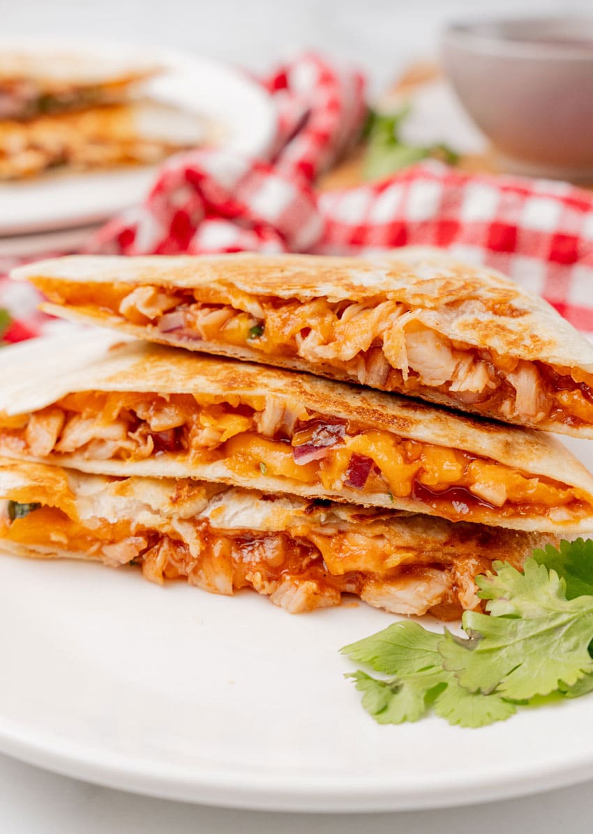 barbecue chicken quesadillas stacked on a white plate