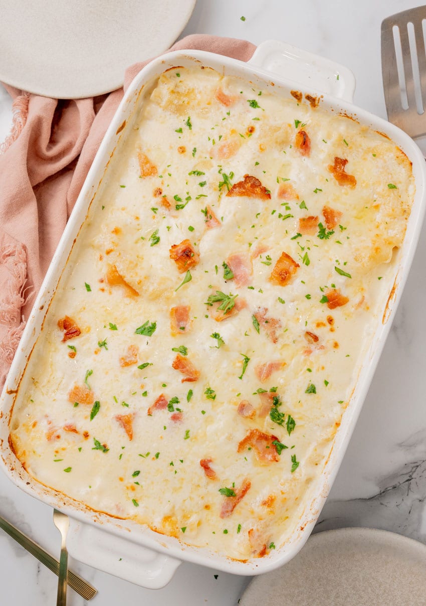 chicken cordon bleu lasagna in a white baking dish